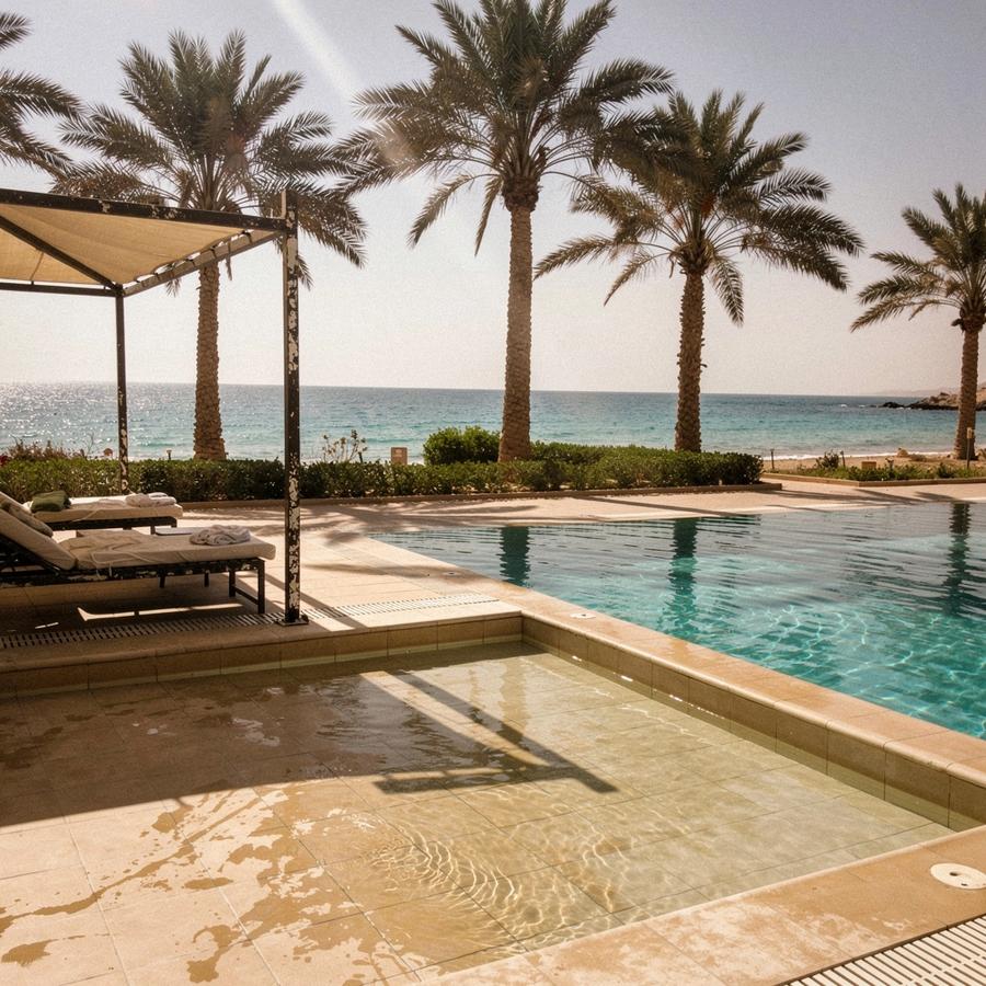 Shaded hotel pool with a shallow children's section and palm trees in Sharm El Sheikh